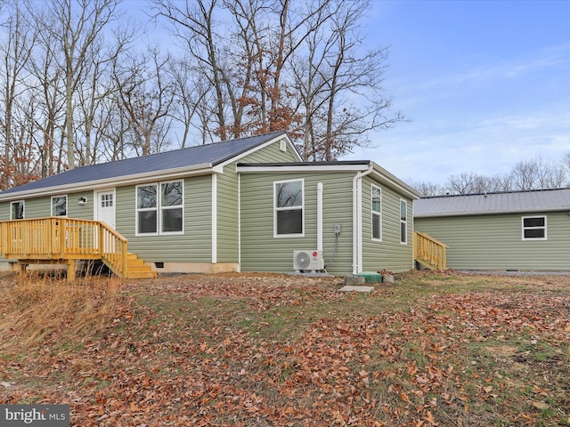 exterior space with ac unit and a wooden deck