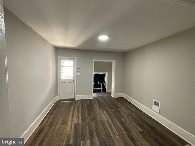 entrance foyer with dark hardwood / wood-style floors