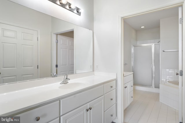 bathroom with independent shower and bath, vanity, and tile patterned flooring