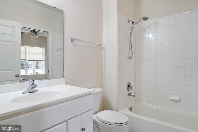 full bathroom with tiled shower / bath, ceiling fan, toilet, and vanity