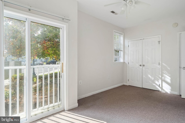 entryway featuring ceiling fan and carpet floors