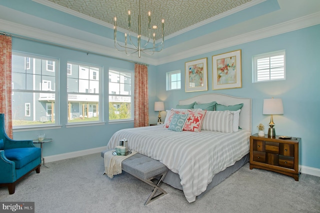 carpeted bedroom featuring ornamental molding, multiple windows, and a raised ceiling