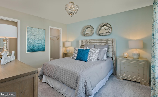 carpeted bedroom with a closet and a walk in closet