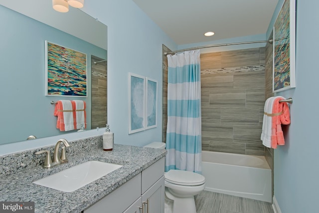 full bathroom featuring toilet, vanity, and shower / bathtub combination with curtain