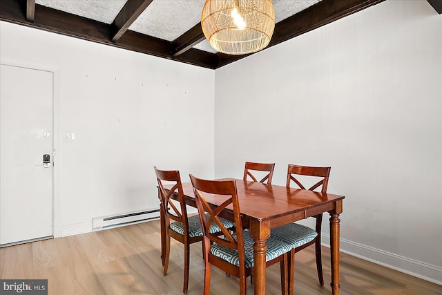 dining area with hardwood / wood-style floors, baseboard heating, beamed ceiling, and a notable chandelier