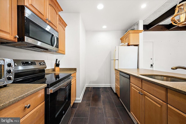 kitchen featuring dark hardwood / wood-style flooring, appliances with stainless steel finishes, and sink