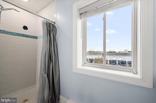 bathroom featuring a shower with shower curtain and plenty of natural light