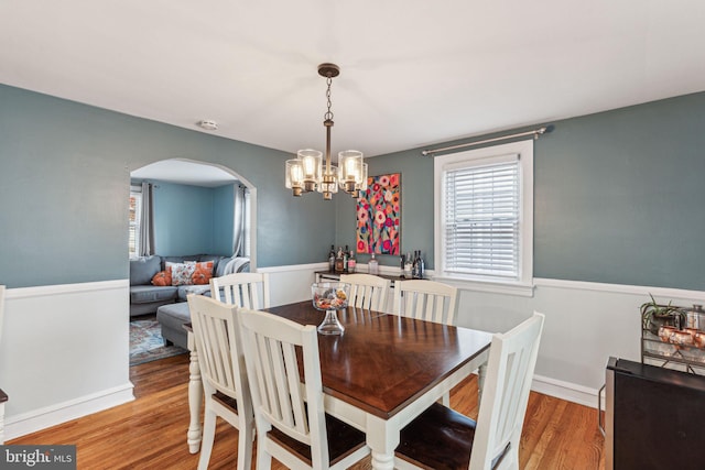 dining area featuring hardwood / wood-style floors and a notable chandelier