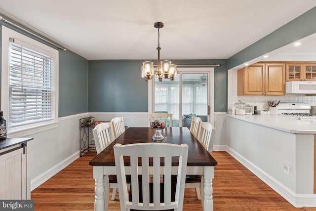 dining room featuring dark hardwood / wood-style floors and an inviting chandelier