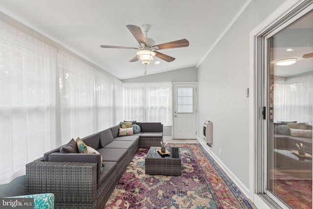 living room featuring heating unit, ceiling fan, lofted ceiling, and ornamental molding