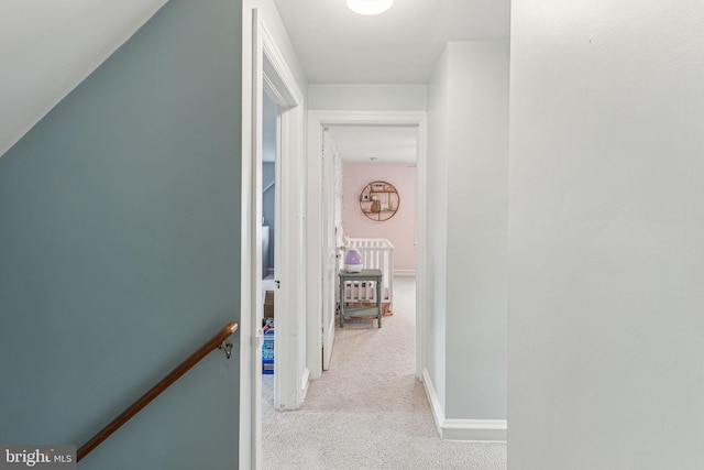 hallway featuring light carpet