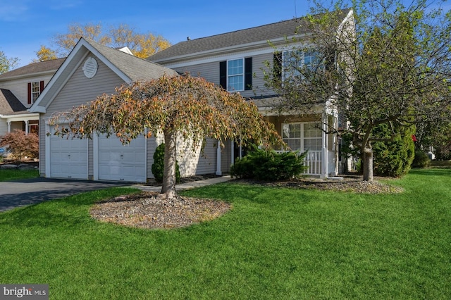 view of property featuring a garage and a front yard