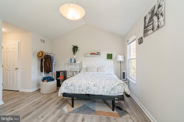 bedroom with light hardwood / wood-style flooring and vaulted ceiling