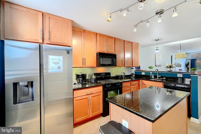 kitchen with sink, black appliances, dark stone countertops, hanging light fixtures, and a center island