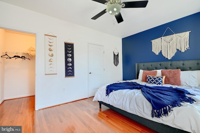 bedroom with hardwood / wood-style floors and ceiling fan