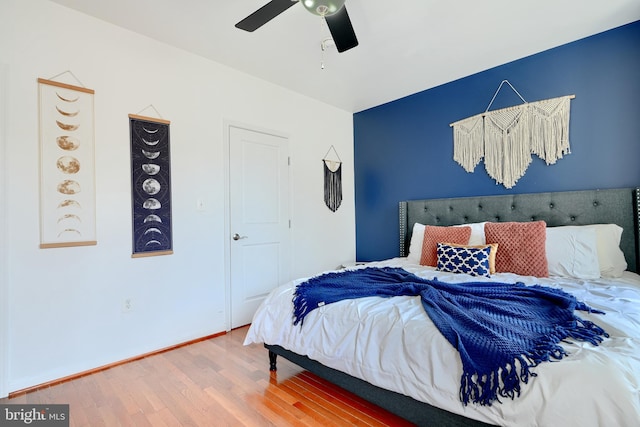 bedroom with hardwood / wood-style floors and ceiling fan