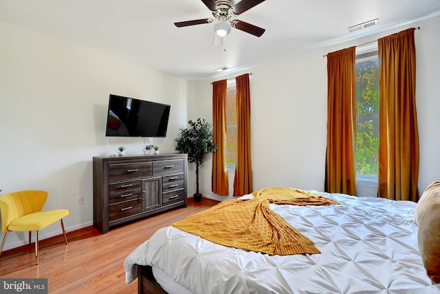 bedroom with ceiling fan and light hardwood / wood-style flooring