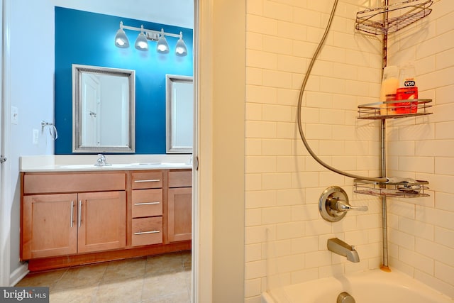 bathroom featuring vanity, tiled shower / bath, and tile patterned floors