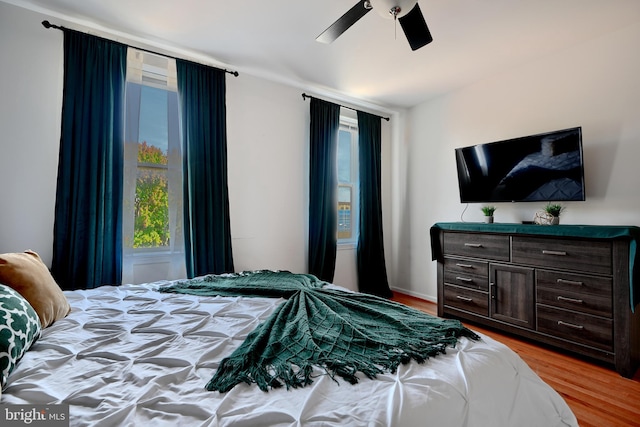 bedroom with light wood-type flooring and ceiling fan