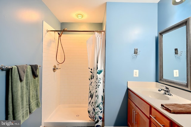 bathroom with curtained shower and vanity