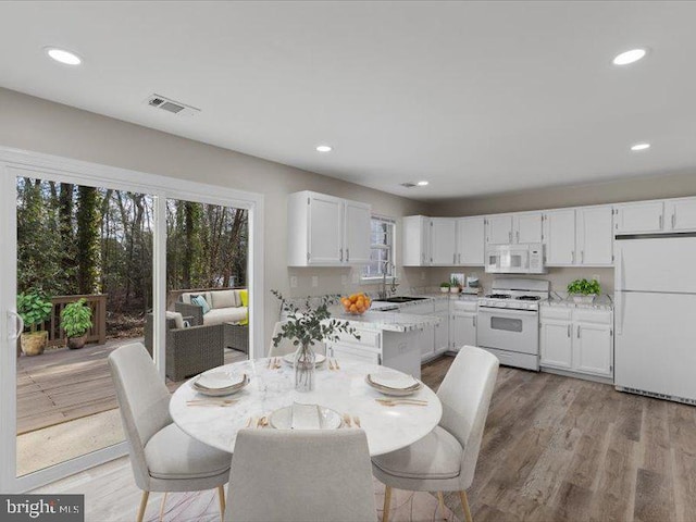 dining area with recessed lighting, visible vents, and light wood finished floors