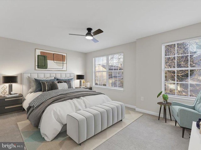 bedroom with light carpet, a ceiling fan, and baseboards