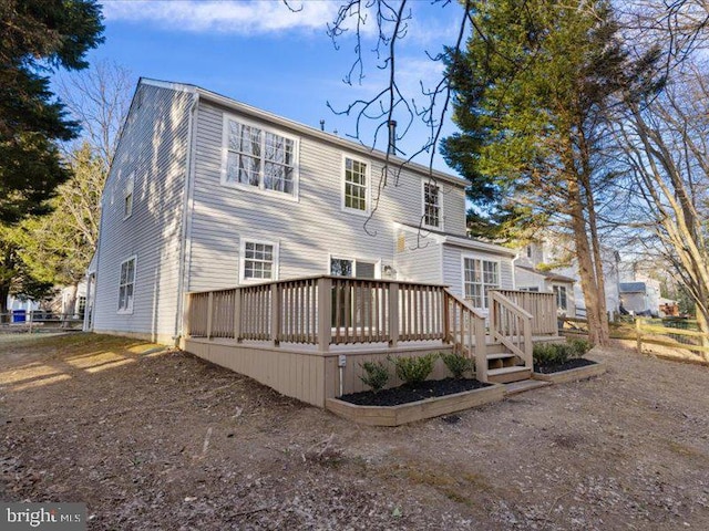 rear view of house featuring a deck