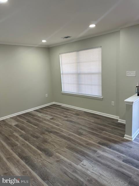 empty room with recessed lighting, visible vents, dark wood finished floors, and baseboards