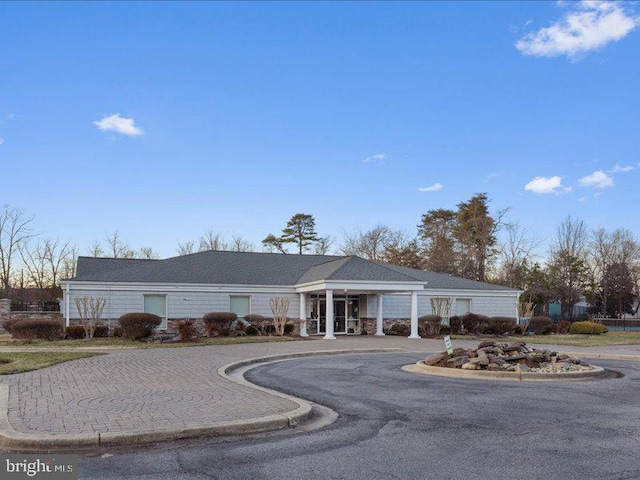 view of property with curved driveway