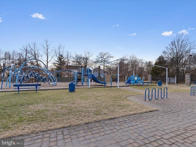 communal playground featuring fence and a yard