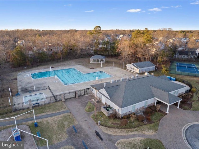 community pool featuring a patio area and fence