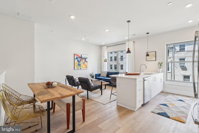 3205 N 35th St Unit 5, Philadelphia, PA 19129 - kitchen featuring stainless steel dishwasher, a peninsula, light wood-style flooring, white cabinetry, and recessed lighting