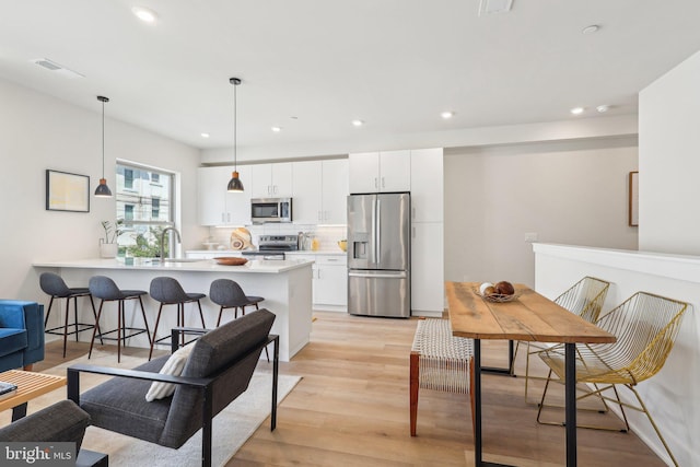 3205 N 35th St Unit 5, Philadelphia, PA 19129 - kitchen with stainless steel appliances, a peninsula, recessed lighting, a sink, and light wood-type flooring