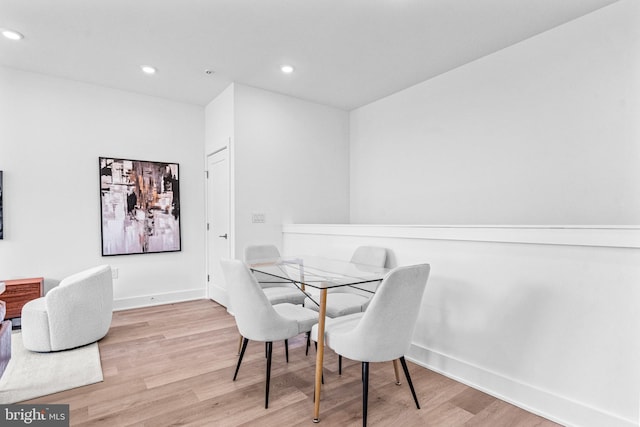 dining space with light hardwood / wood-style flooring