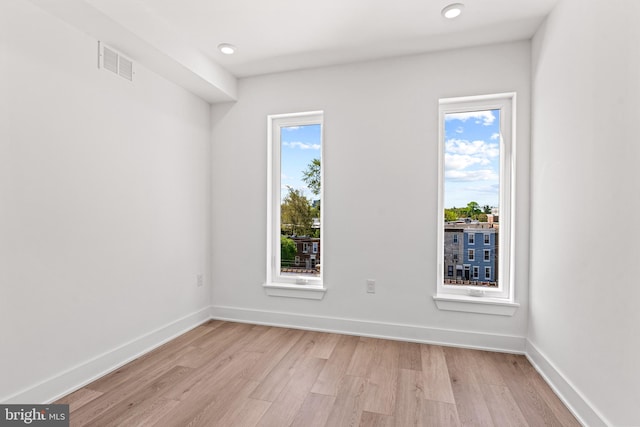 spare room featuring light hardwood / wood-style flooring