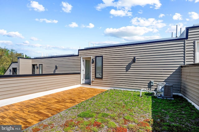 exterior space with a lawn and central air condition unit