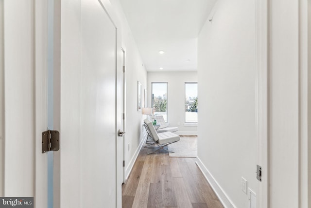 corridor with light hardwood / wood-style floors