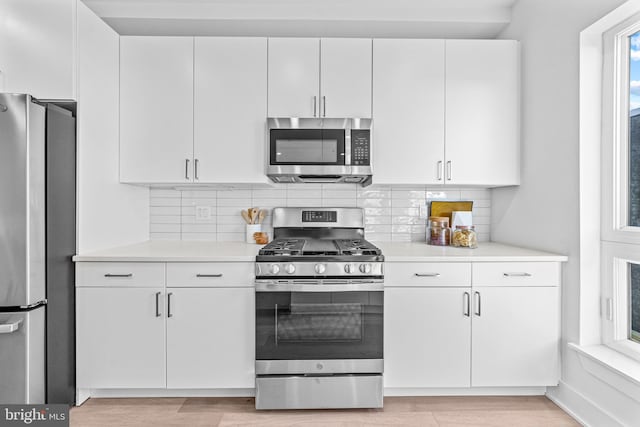 kitchen featuring white cabinetry, a wealth of natural light, and stainless steel appliances