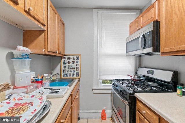 kitchen featuring light tile patterned floors and gas stove