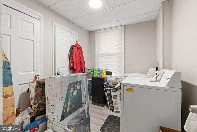 washroom with washer and clothes dryer and light hardwood / wood-style floors