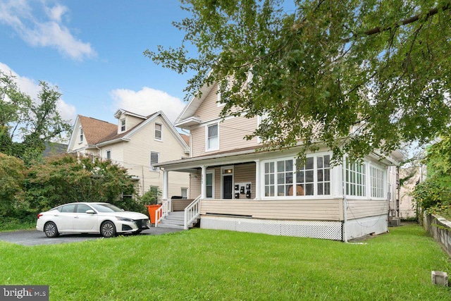 view of front of house with a porch and a front lawn