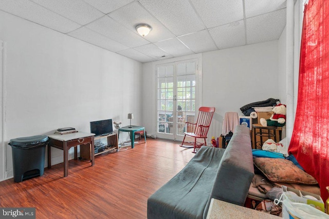 interior space with dark hardwood / wood-style floors and a paneled ceiling