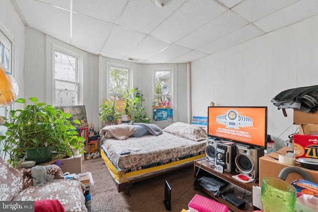 carpeted bedroom with a paneled ceiling