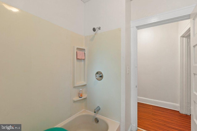 bathroom with hardwood / wood-style flooring and shower / bathing tub combination