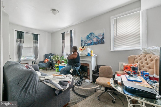 home office with a brick fireplace and carpet flooring