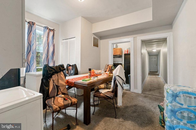 dining room featuring washer / clothes dryer and carpet flooring