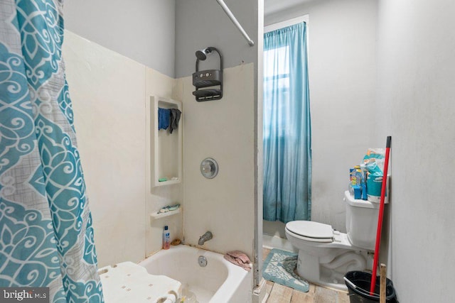 bathroom with toilet, shower / bath combo with shower curtain, and hardwood / wood-style flooring