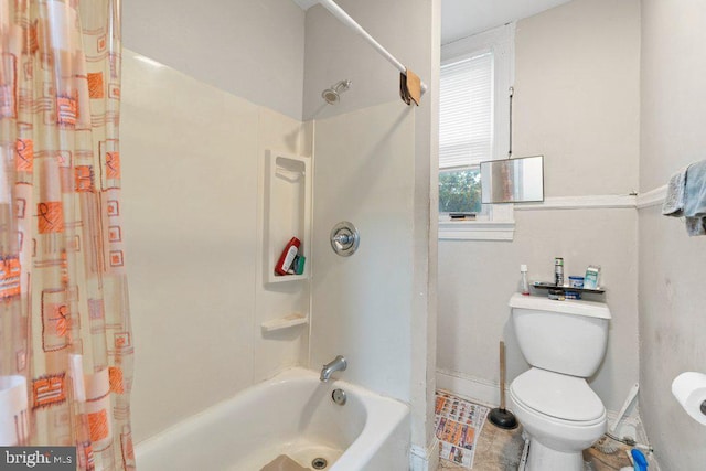 bathroom featuring shower / bath combo and toilet