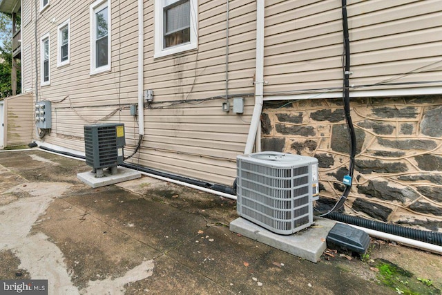 view of side of property featuring central AC and a patio