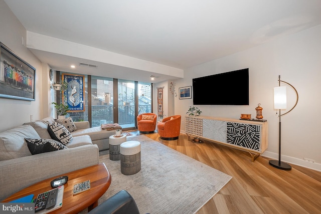 living room with hardwood / wood-style flooring and expansive windows